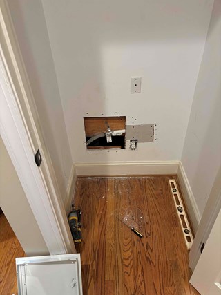 A wall with a section cut out for an access panel.