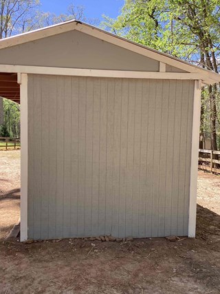 Shed, with the wall repaired and in a much cleaner, undamaged condition.
