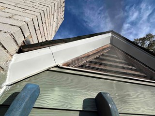  The fascia board has been replaced with new, clean white material, and the trim has been properly sealed and caulked.