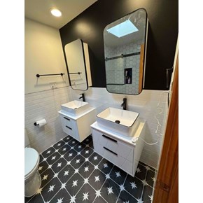 Contemporary bathroom remodel in Chapel Hill, NC featuring new tile, modern vanities, and a full room paint job