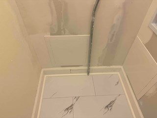 The walls have been repaired, repainted, and smoothed. Two new access panels have been installed on the walls, providing a cleaner and more organized appearance.