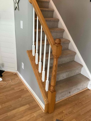 The repaired staircase with all balusters properly secured in place.