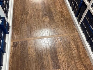 The damaged section has been restored, blending seamlessly with the surrounding floor. 