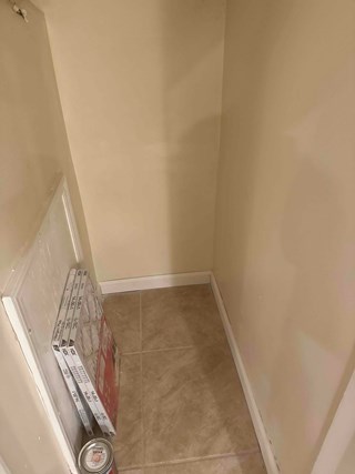 Closet corner after drywall repair, now smoothly patched and painted to match the surrounding walls. 