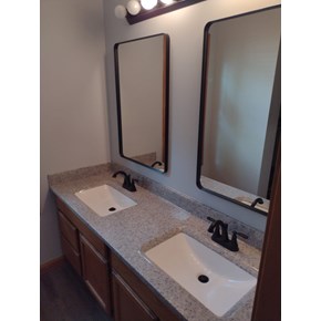 Ace Handyman Services handyman installed an Onyx Collection Products vanity with double integrated sinks and delta faucets.