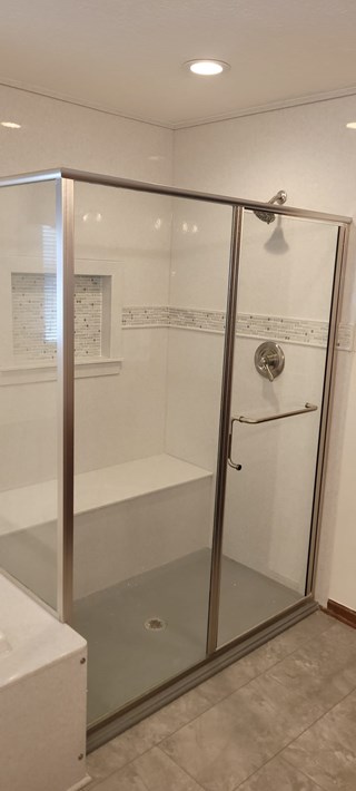 After Ace Handyman Services remodeled this bathroom using Onyx Collection Products for the shower surround, base, customer sitting bench, decorative inlay, and glass door in Gahanna, Ohio
