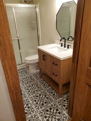 After Ace Handyman Services refresh in bathroom including new flooring, vanity, countertop, fixtures, and mirror in Westerville, Ohio