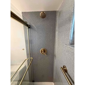 Ace Handyman Services handyman installed an Onyx Collection shower surround, shower base, and barn door sliding glass door. We also installed Delta fixtures and grab bars to match in Dublin, Ohio.