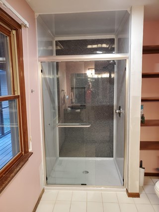 After Ace Handyman Services remodeled this bathroom in Baltimore, Ohio using Onyx Collection products including a shower surround, base, accessories and sliding glass door