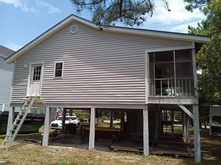 House exterior repair in Surfside Beach, SC after replacing rotten wood, window, door, and siding.