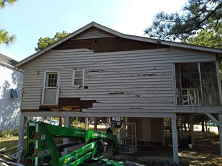 House exterior repair in Surfside Beach, SC before removing siding, replacing some joists, plywood, window, and door.