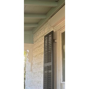 Repaired porch reattached to historic Fredericksburg, TX home after foundation damage.
