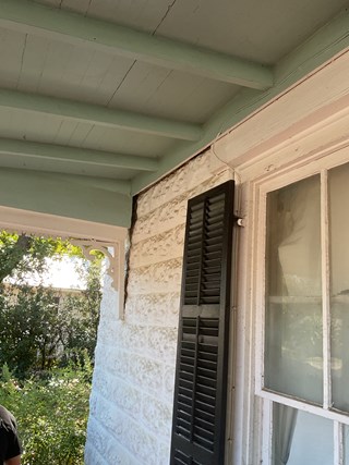 Repaired porch reattached to historic Fredericksburg, TX home after foundation damage.