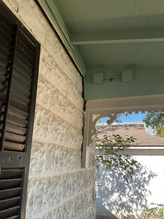 Repaired porch reattached to historic Fredericksburg, TX home after foundation damage.