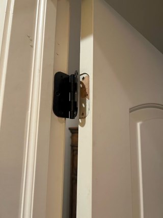Damaged Door Hinge and Misaligned Door in Central Houston