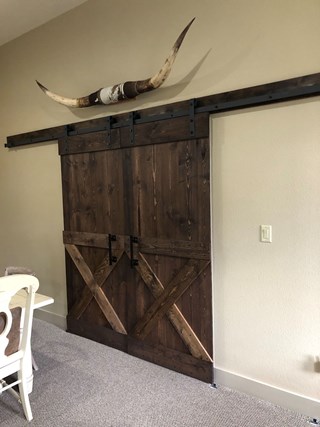 After custom built sliding barn door in New Braunfels Texas