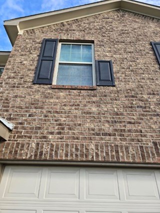 Missing and Uneven Exterior Shutters on Second-Floor Window