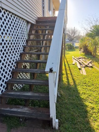Worn-out stairs and porch with visible damage and aging wood in Pearland