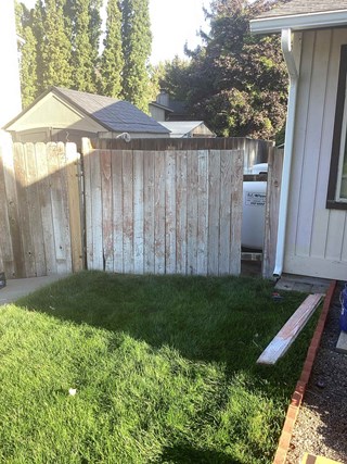 Before and after photo of a wooden fence repaired by Ace Handyman Services in Kennewick, WA, restoring privacy and durability.