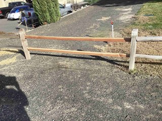 Handyman fixing broken fence boards in a backyard in Kennewick, WA, ensuring a polished and secure look