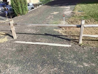 Damaged wooden fence in Kennewick, WA, repaired and refinished by Ace Handyman Services of Tri-Cities