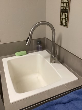 Before and after photo of a kitchen sink faucet replaced by Ace Handyman Services in Kennewick, WA, upgrading to a modern, efficient fixture.