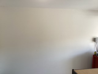Before and after photo of a new vinyl window installation in a garage wall by Ace Handyman Services in Kennewick, WA, adding natural light and ventilation.