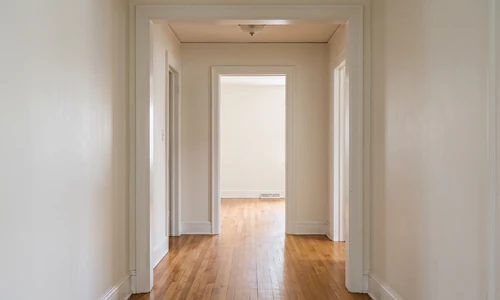Empty interior door opening in a finished hallway showing the full height from floor to header