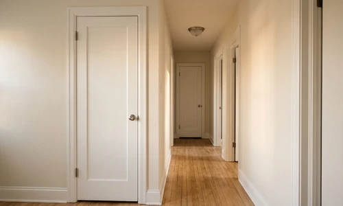 Tidy repaired hallway with freshly painted walls, new trim, and a closet door hanging square