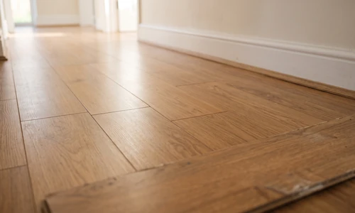 Repaired laminate floor after plank replacement, seams tight and finish matched to the surrounding boards