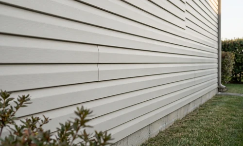 Repaired run of vinyl lap siding lying flat and true, courses locked down evenly with aligned butt seams