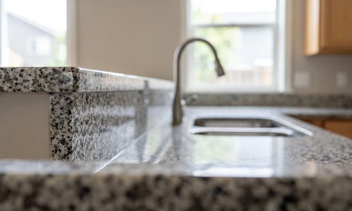 Finished granite countertop repair blended into the stone surface, shown under bright natural light