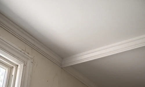Photorealistic wide shot of a finished residential interior wall and ceiling corner with smooth orange peel