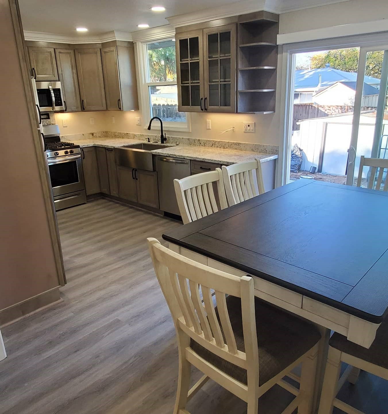 Modern kitchen with wooden cabinets and dining area.
