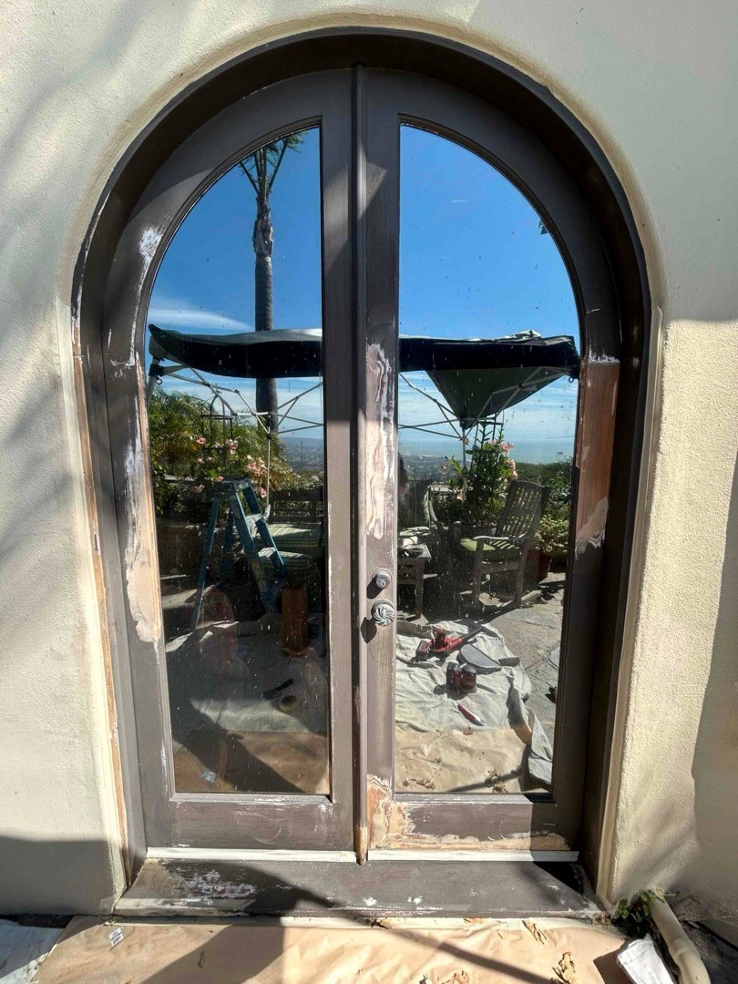 Arched double doors during prep, Huntington Beach Arched double doors partway through sanding and prep for a refinish on a Huntington Beach home