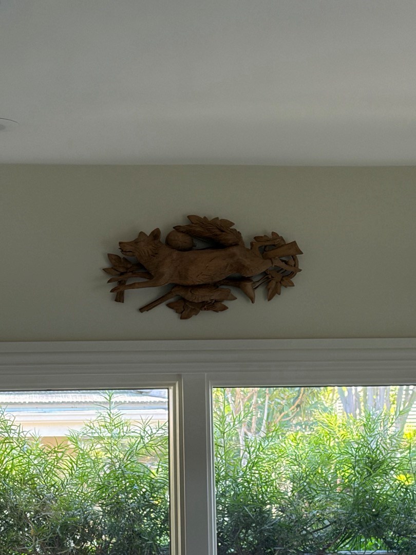 Decorative wall piece hung above a window in a Newport Beach home
