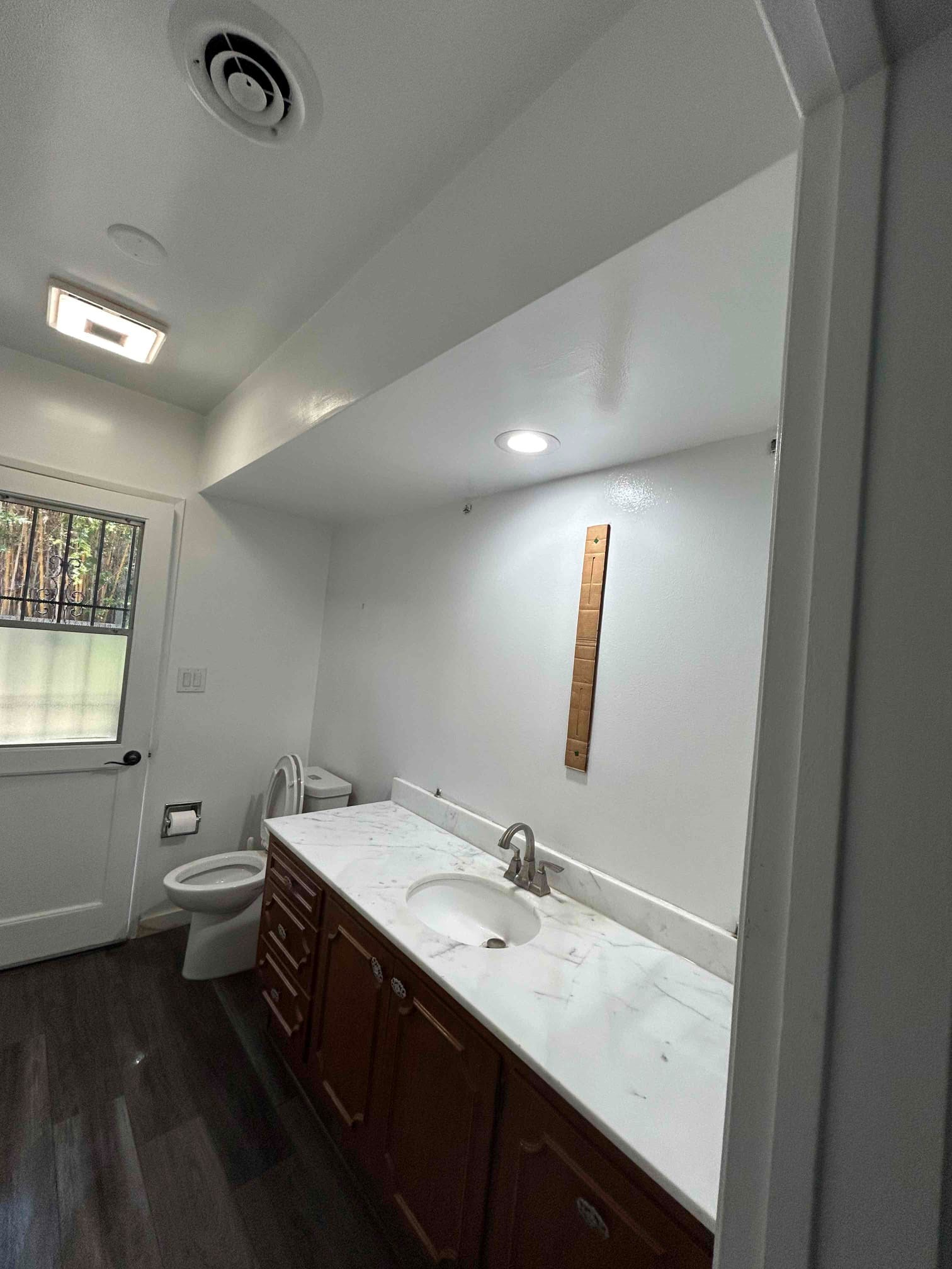 https://acehandyman-dss.ingeniuxondemand.com/Images/Offices/California/Coastal Orange County/Images/ceiling handyman after job.jpg Bathroom ceiling opened around the duct during a repair in Huntington Beach, toilet wrapped and room sealed with plastic containment