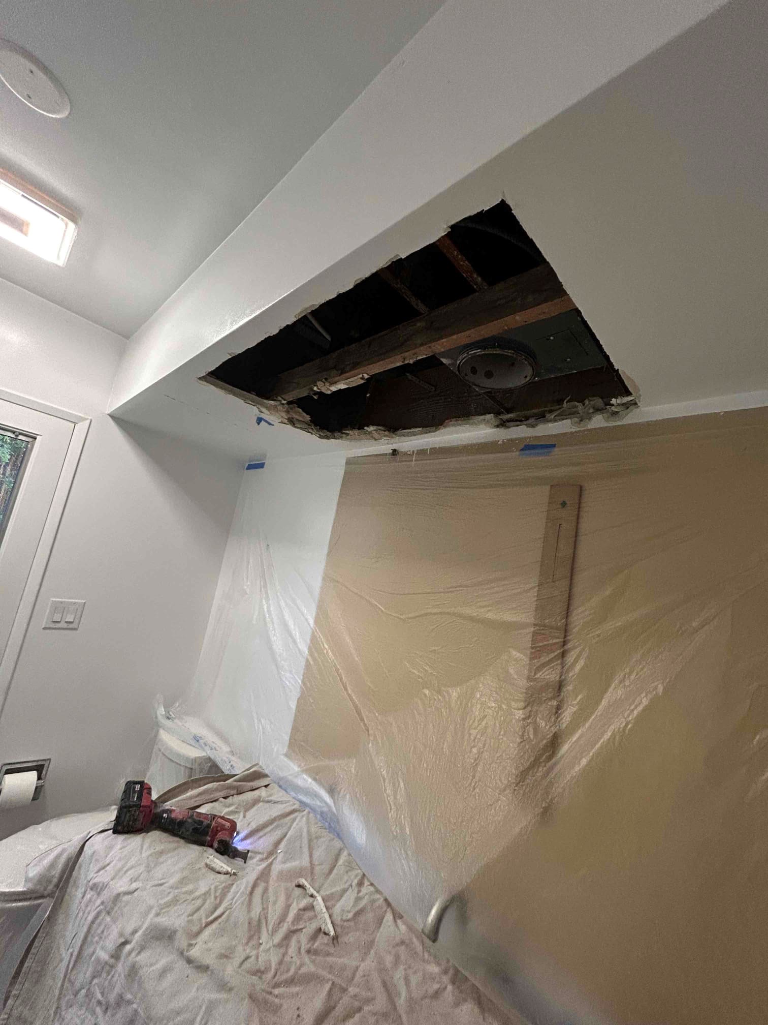 https://acehandyman-dss.ingeniuxondemand.com/Images/Offices/California/Coastal Orange County/Images/ceiling handyman.jpg Bathroom ceiling opened around the duct during a repair in Huntington Beach, toilet wrapped and room sealed with plastic containment
