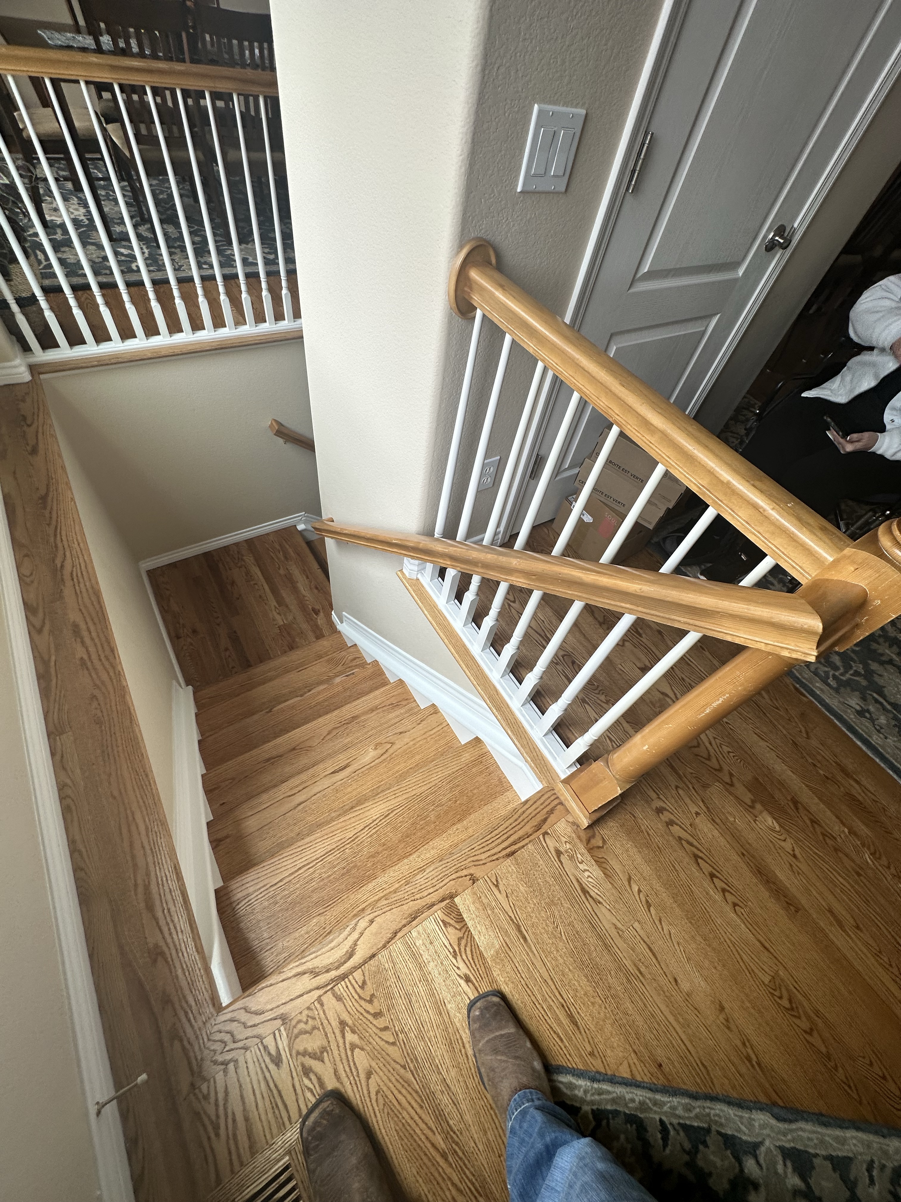Wooden staircase with new railing installation from above view.
