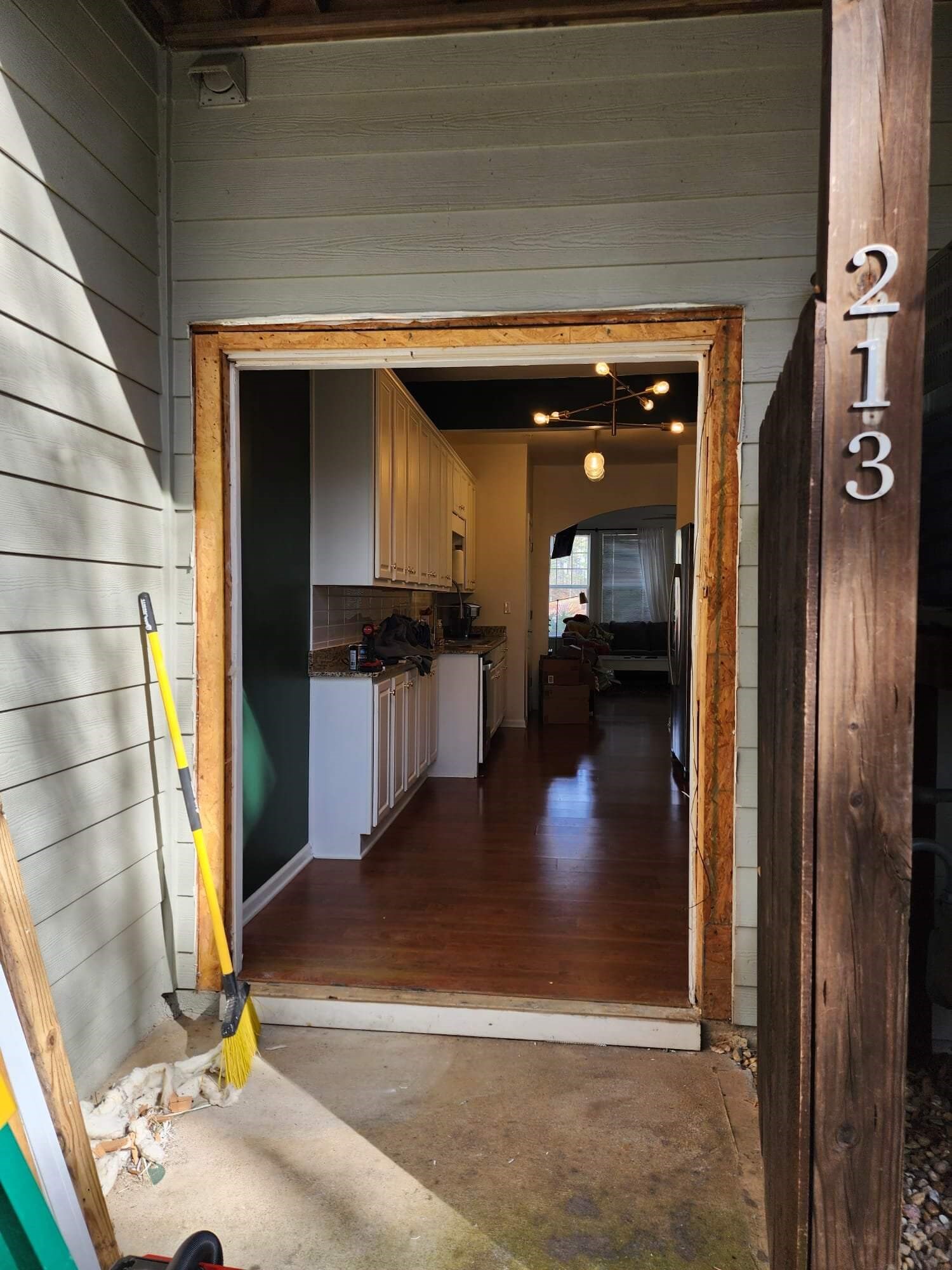 Open doorway to an unfinished kitchen remodel project.