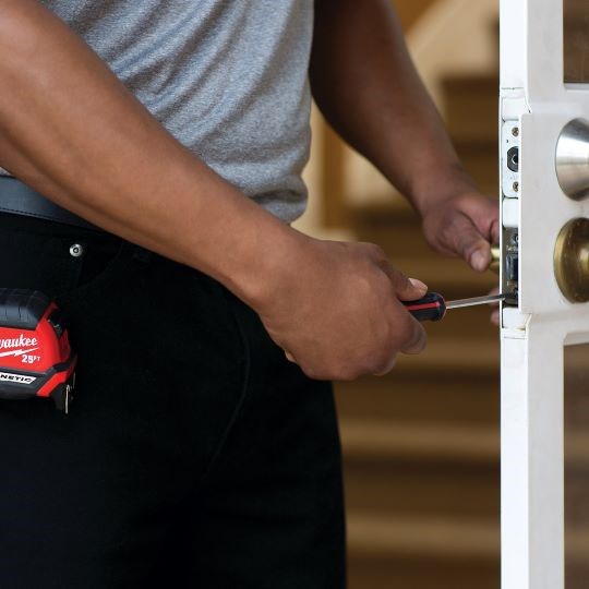 https://acehandyman-dss.ingeniuxondemand.com/Images/Offices/Illinois/Fox Valley/Blog/Door repair.png Handyman Repairing Door