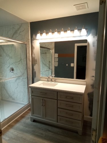 Bathroom renovation with vanity and shower stall.