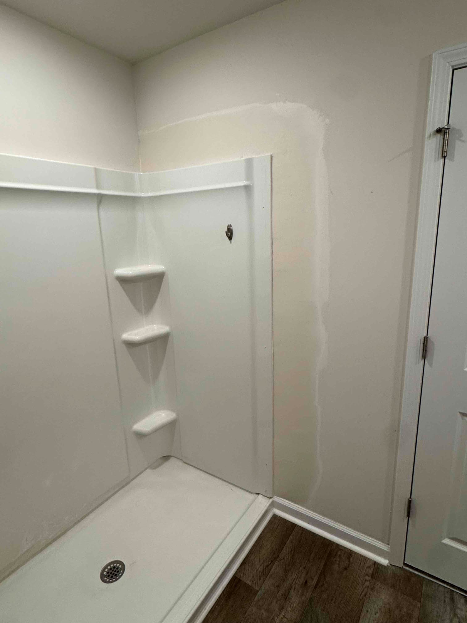 https://acehandyman-dss.ingeniuxondemand.com/Images/Offices/North Carolina/Clayton/31864601-ace-handyman-services-clayton-clayton-nc-27520-bathroom-drywall-repair-shower-surround-mudding.jpg Joint compound feathered along shower surround edges during drywall repair Clayton, NC.