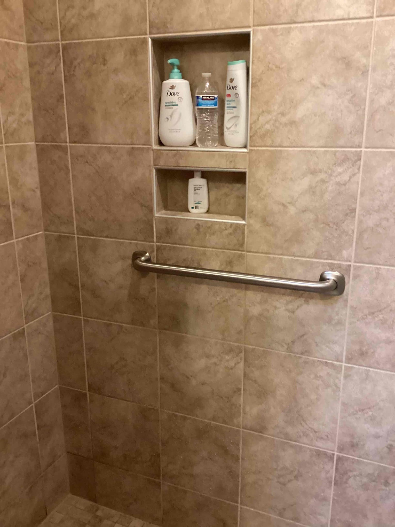 Grab bar installed into tile shower under a shower niche in Flowers Plantation NC