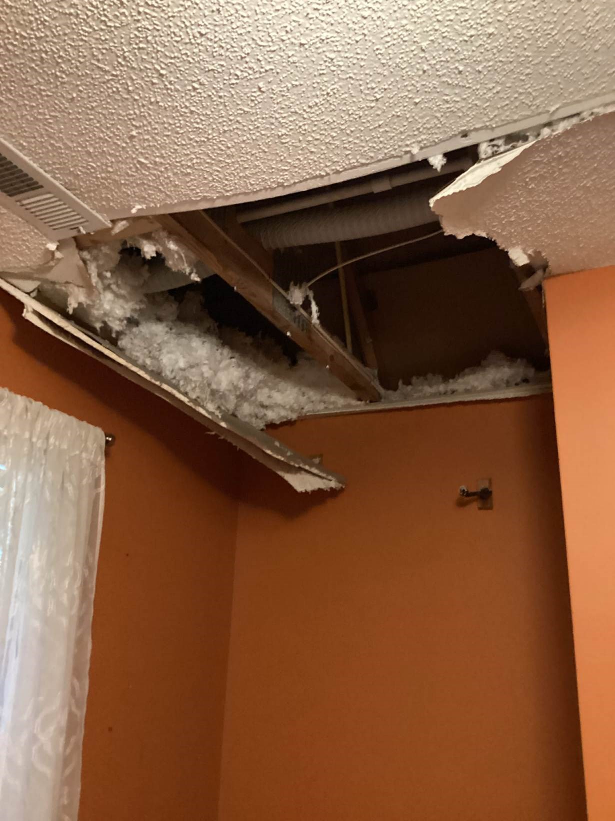 Collapsed popcorn ceiling exposing insulation and HVAC after water damage in a Southwest Durham, NC home before repair by Ace Handyman Services