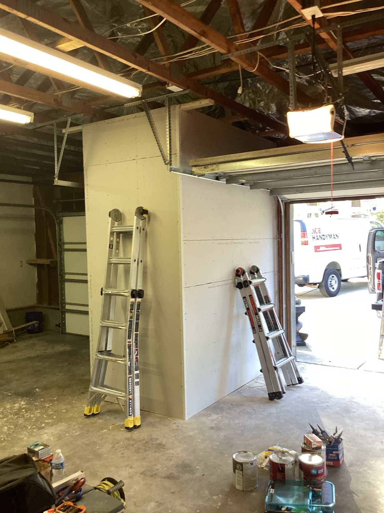 Built garage wall with new drywall installation and an Ace Handyman Services branded vehicle visible at a Southwest Durham, NC home