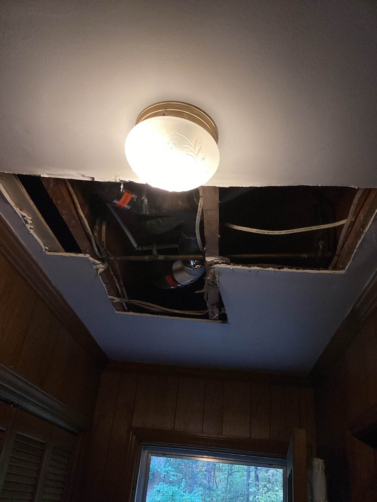Ceiling opened up to access plumbing for repair in a West Durham, NC home before drywall repair by Ace Handyman Services