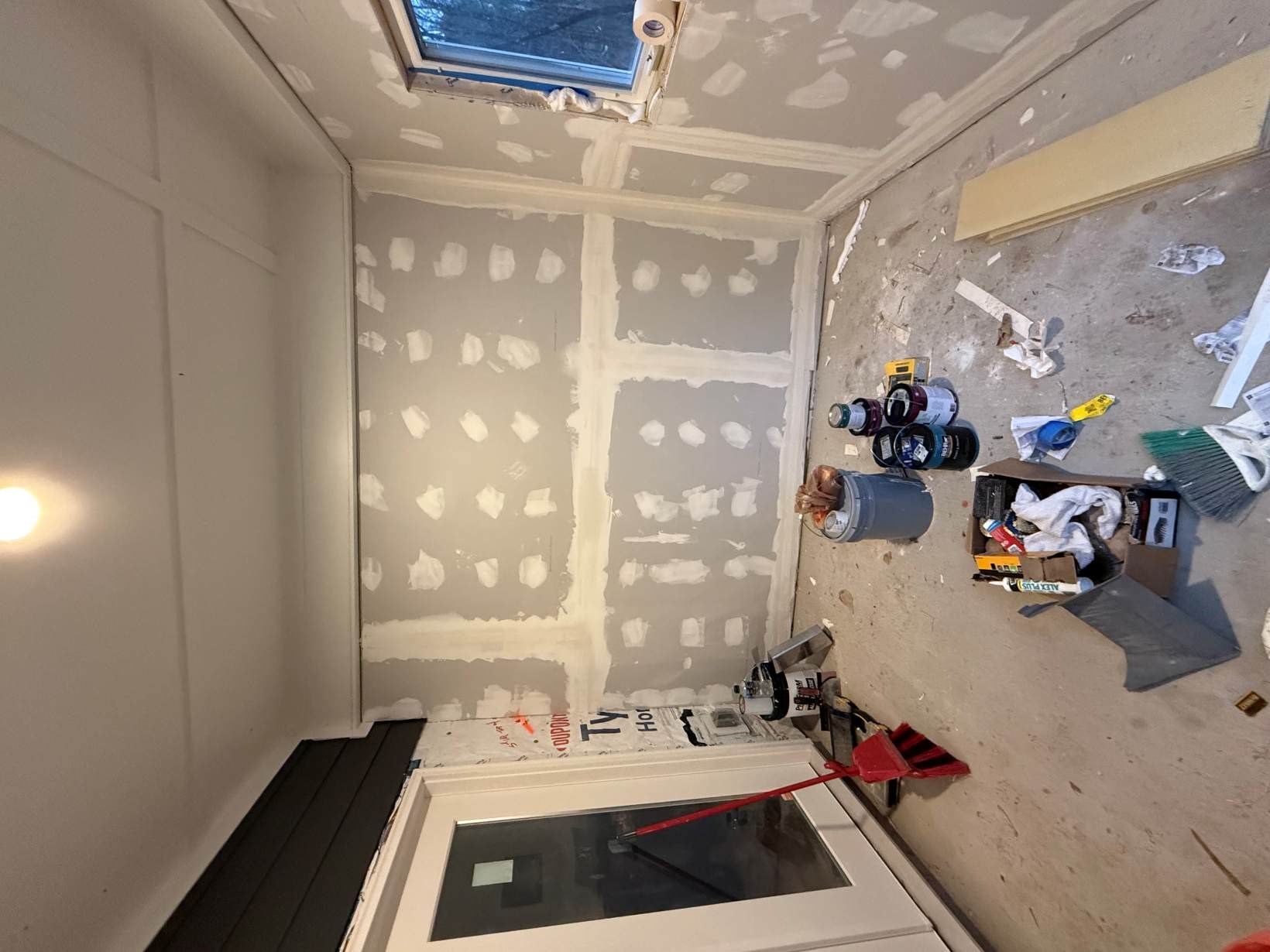 Newly hung and mudded drywall on the walls and ceiling of an enclosed porch in a North Durham, NC home by Ace Handyman Services