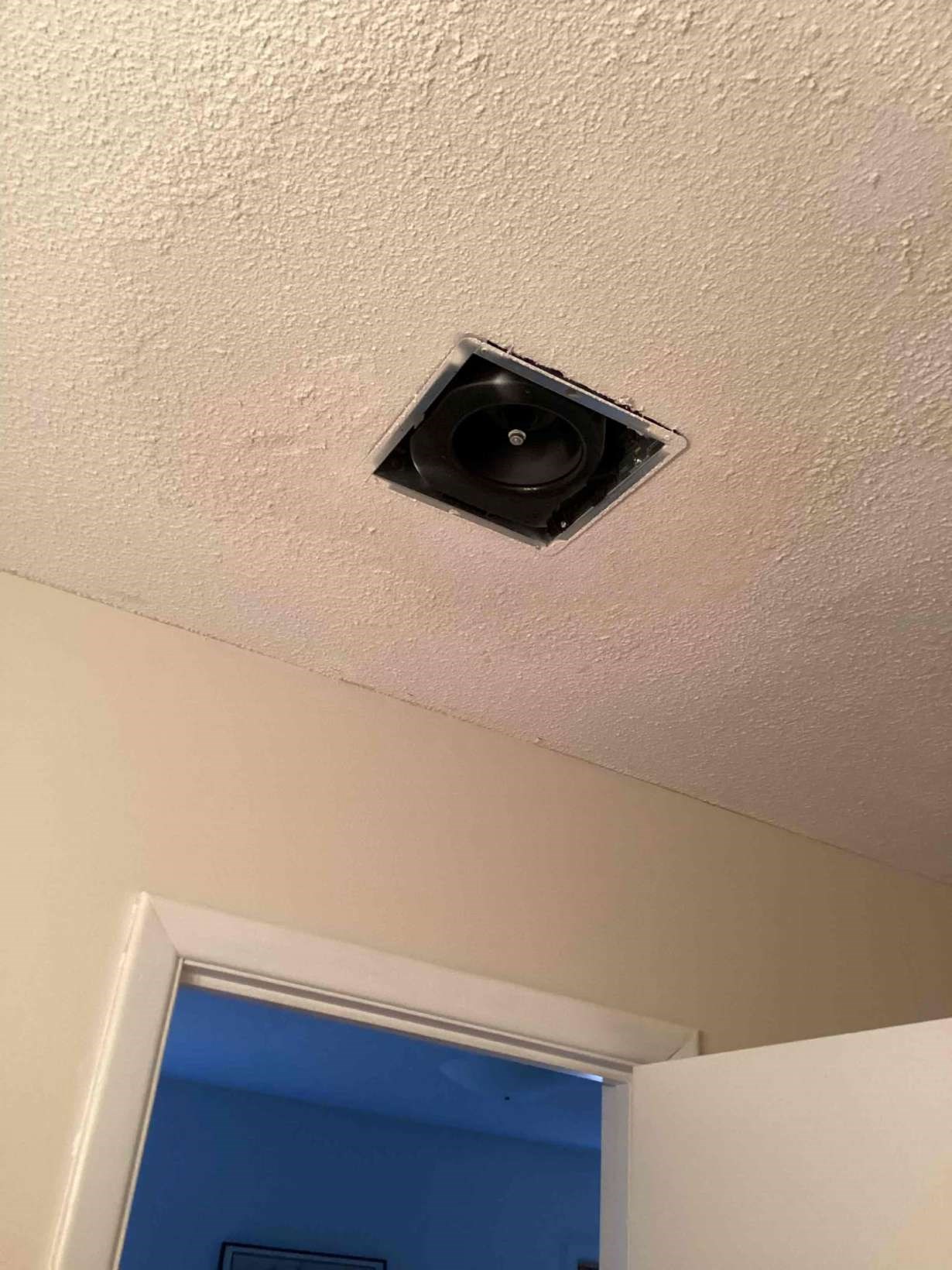 Smoothly repaired popcorn ceiling with bath vent fan reinstalled in a Southwest Durham, NC home by Ace Handyman Services