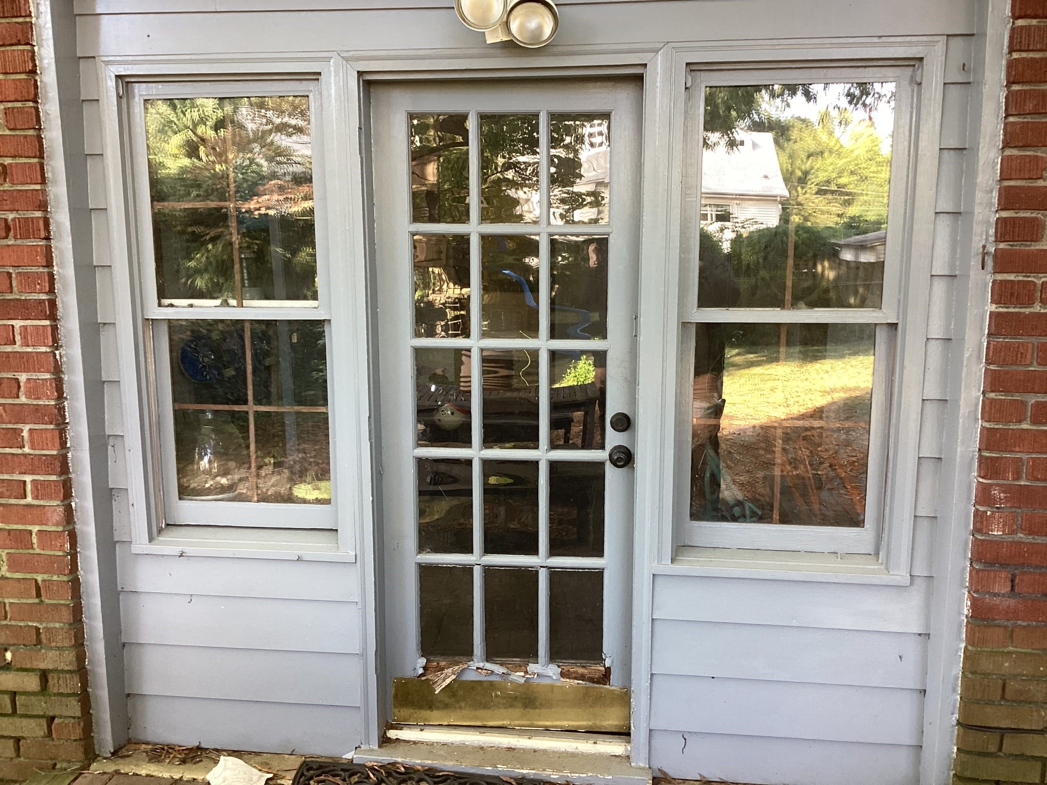 Damaged exterior door before replacement in Raleigh, NC 27605.